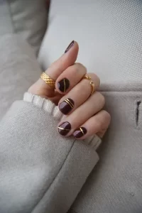 Maroon Nails and Gold Lines